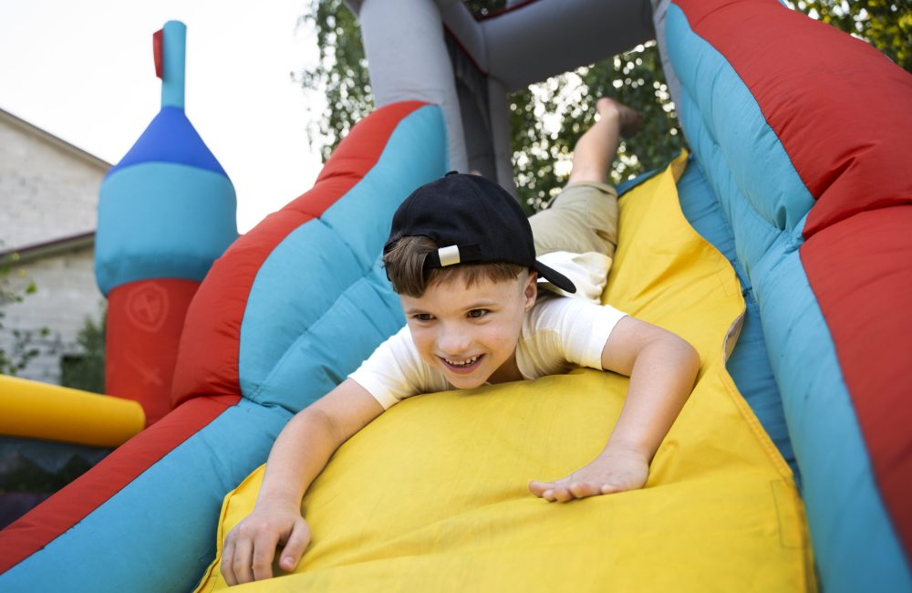 low-angle-smiley-kid-playing-bounce-house